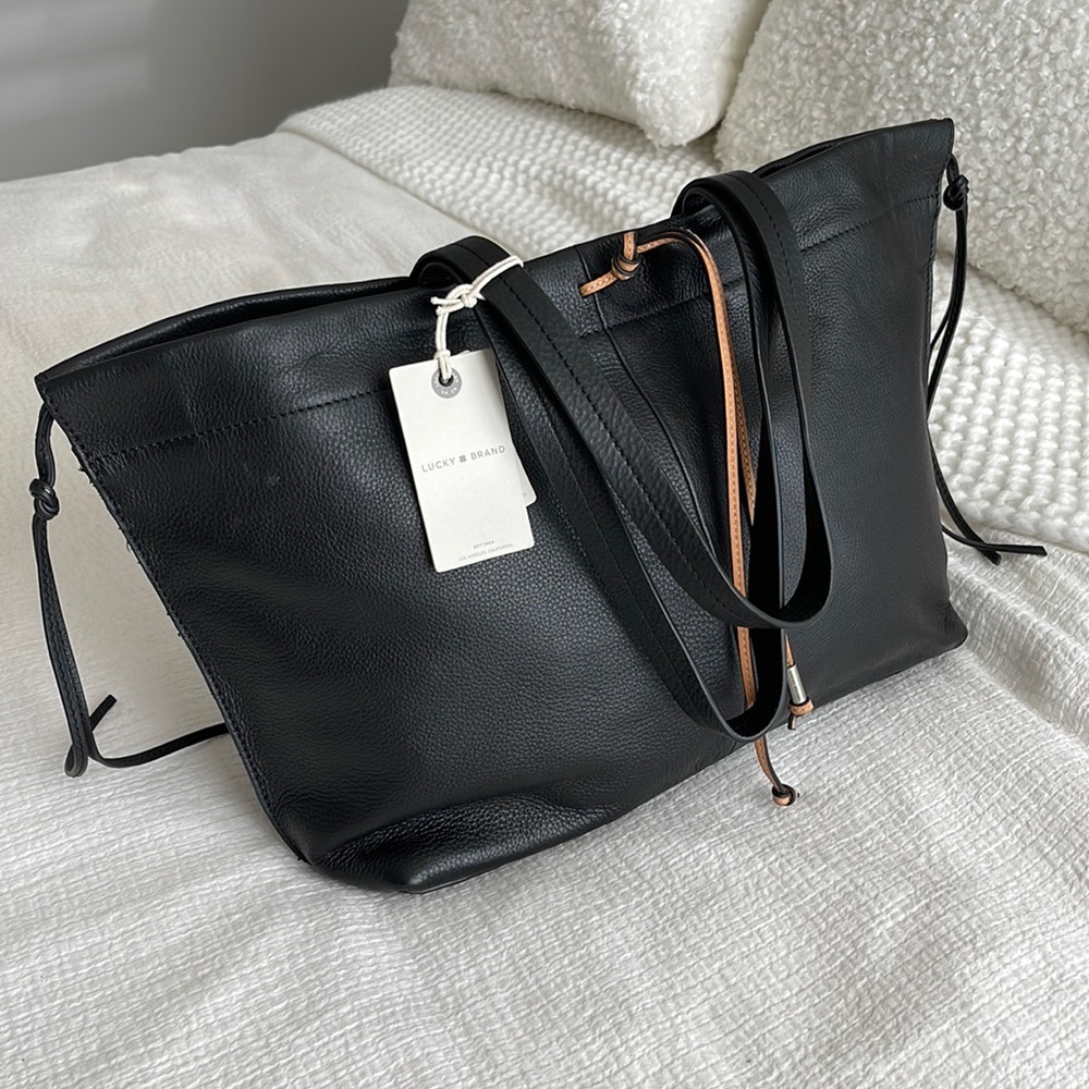 Brand new, with tags Lucky Brand black, pebble grain leather purse.